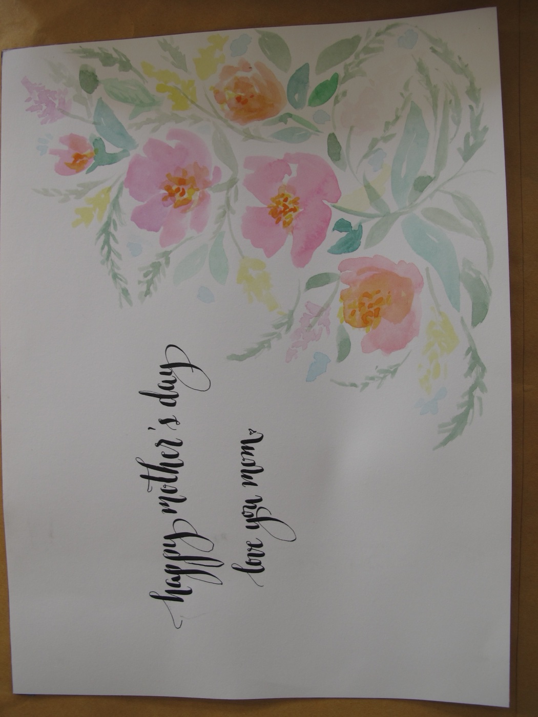 The original watercolour flower artwork the homeowner drew by hand, beside the finished printed fabric