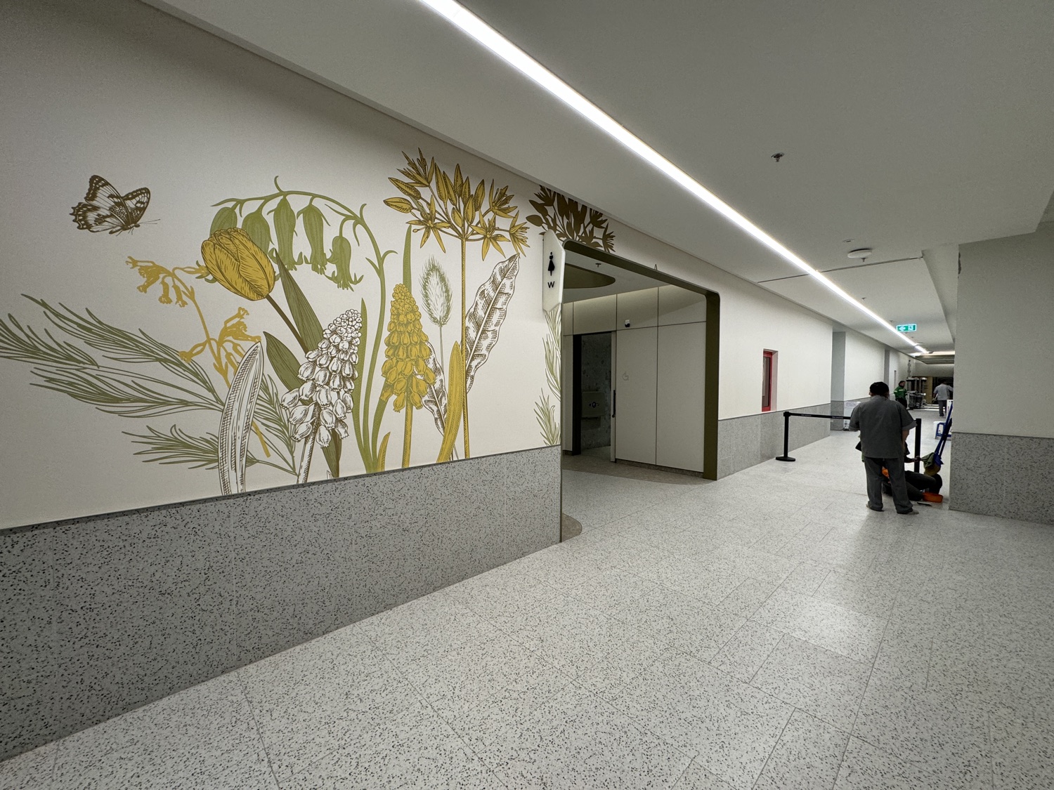 Botanical art wall with butterflies in green and gold, custom-printed for One Bangkok